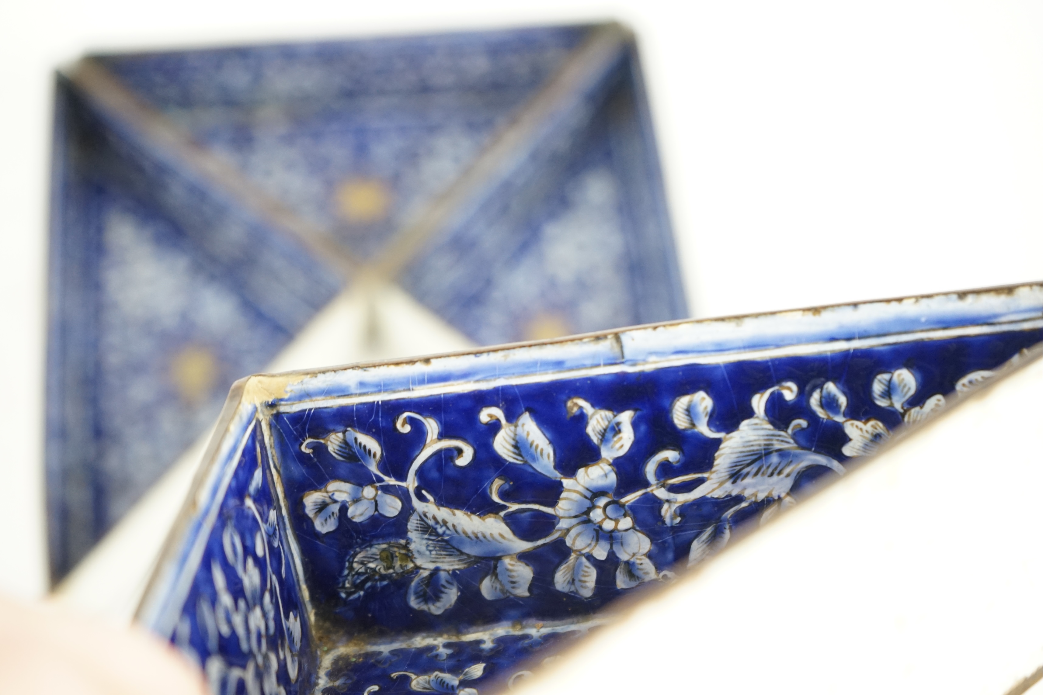 Four triangular 19th century Chinese Canton enamel sectional dishes, later boxed, 24cm wide overall. Condition - some restoration